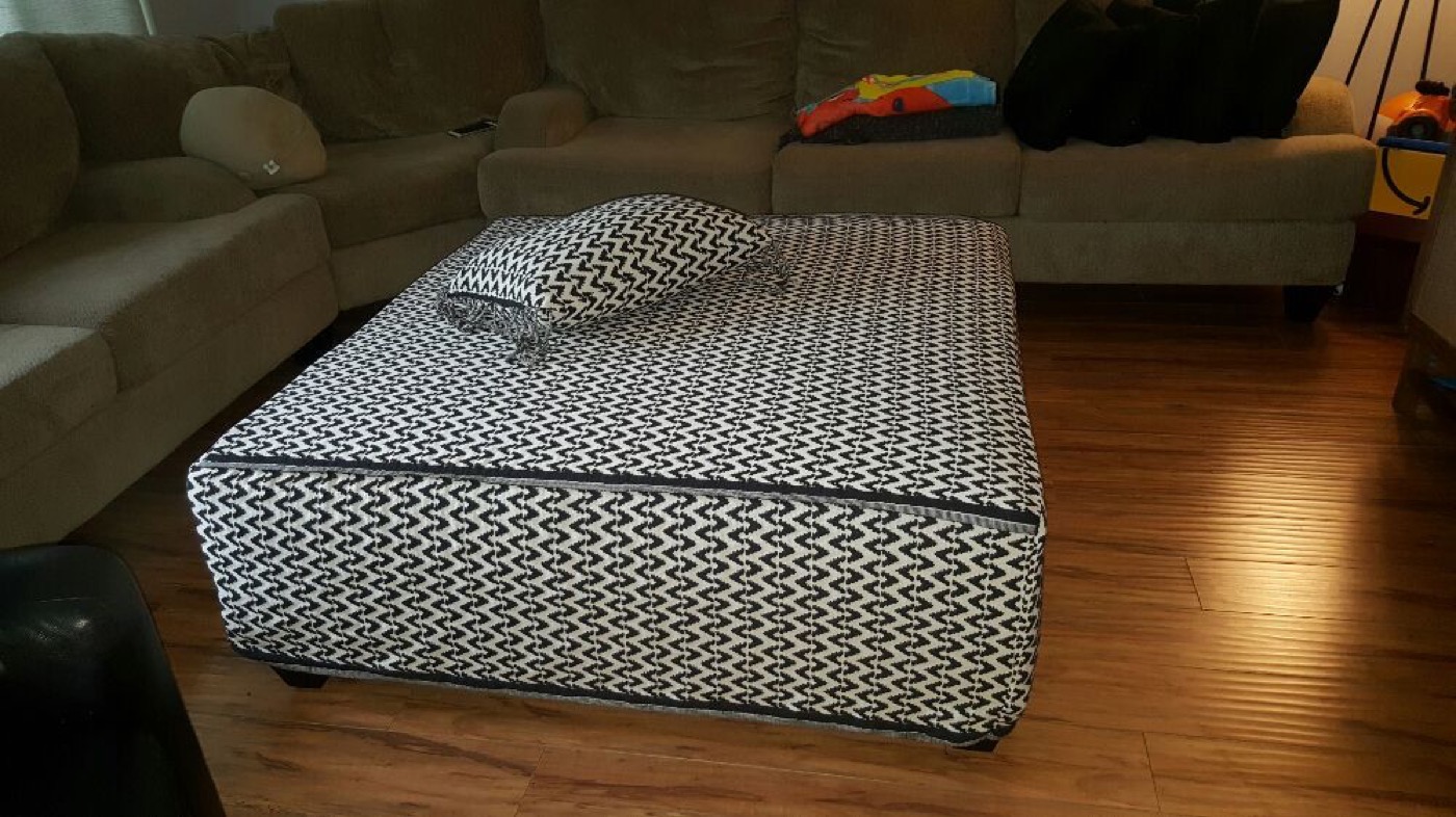 A large box cushion in a black and white geometric weave, made to fit.
