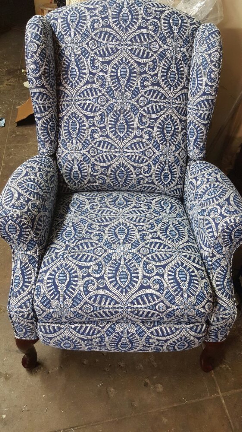 A wing chair in a blue and cream paisley.