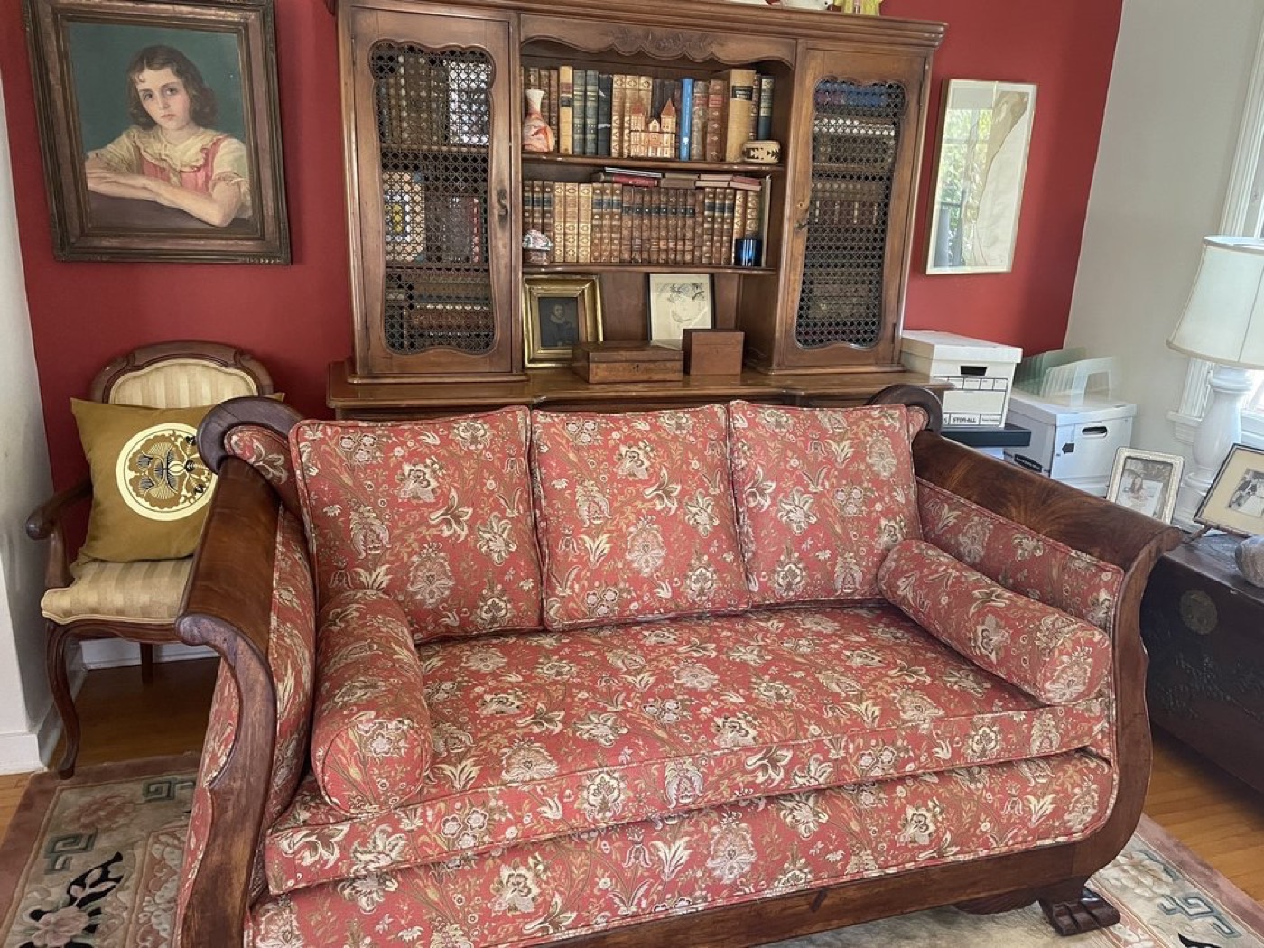 An antique settee reupholstered in a coral and cream floral.